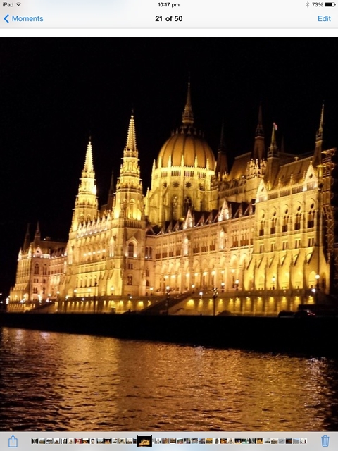       The illuminated front of the Hungarian Parliament Building at night.
  