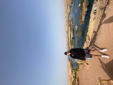       Repeat image of traveler overlooking the Nile River from a desert bluff.
  