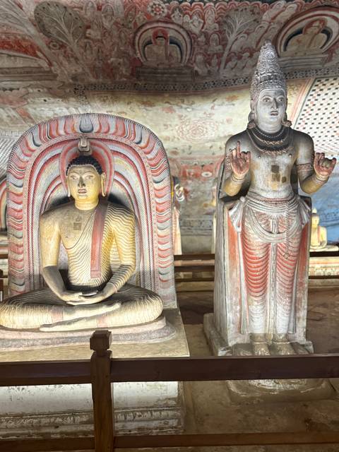       Intricately painted Buddha statues inside the ancient Dambulla Cave Temple.
  
