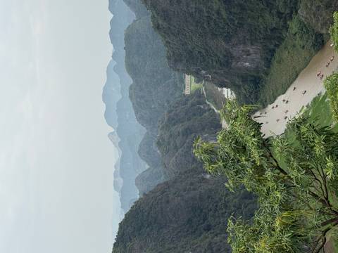       View from Hang Mua over a winding river between karst mountains in Ninh Binh under cloudy skies.
  