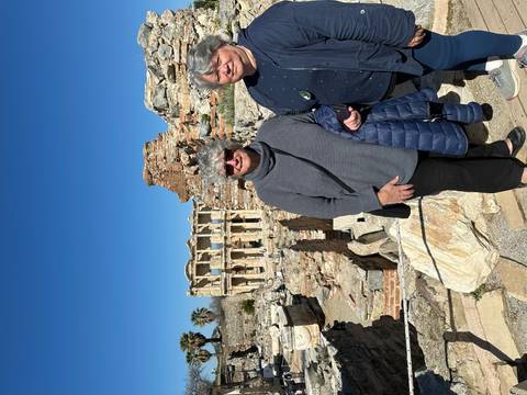       Two women stand before the ancient Library of Celsus ruins at Ephesus.
  