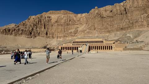       Wide courtyard facing the terraced limestone Temple of Hatshepsut set against towering cliffs
  