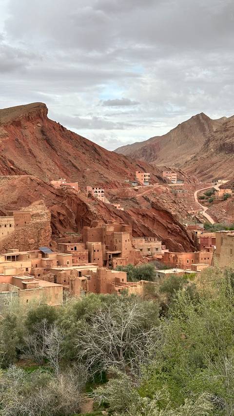       Berber clay village built into dramatic red mountains and ravines.
  