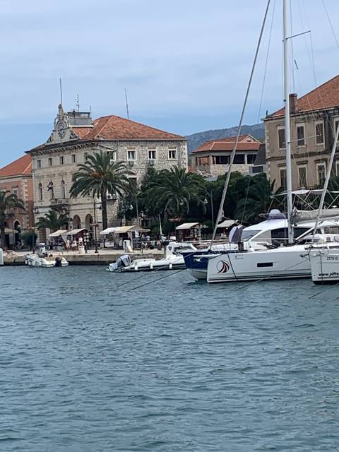       Scenic view of a harbor with yachts and historic buildings.
  
