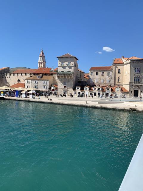 Historic coastal town with a blend of stone buildings and calm waters.