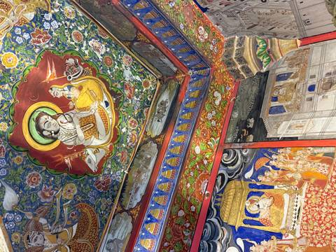       Ornate ceiling mural featuring colorful mythological figures and decorative patterns.
  