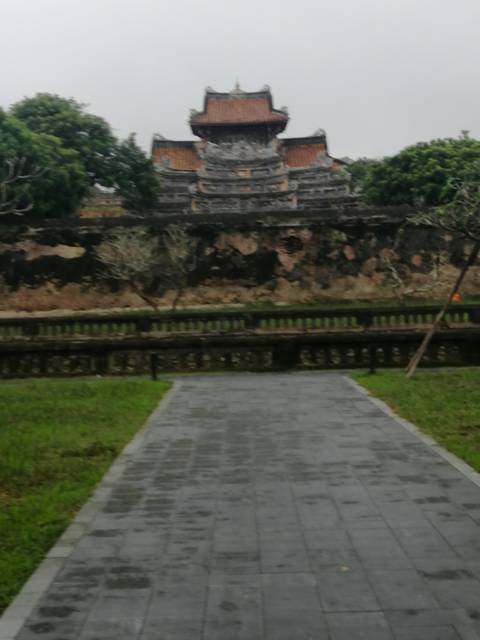       Out-of-focus image of a stone wall and walkway in a garden setting
  