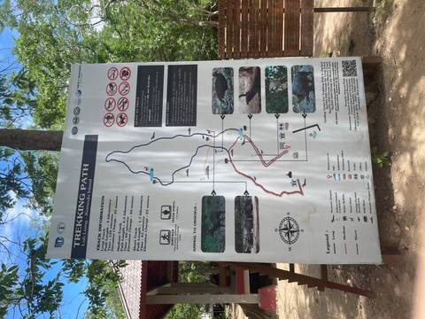       Tall information board showing trekking routes and wildlife tips for Komodo National Park.
  