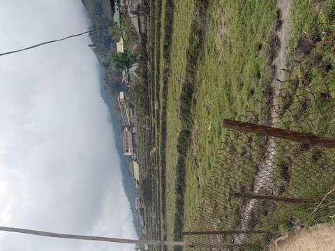       Fog-covered rice terraces and scattered village houses in a mountainous rural landscape.
  