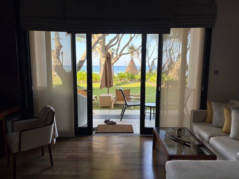       View from hotel room out to a patio and the Indian Ocean beyond
  