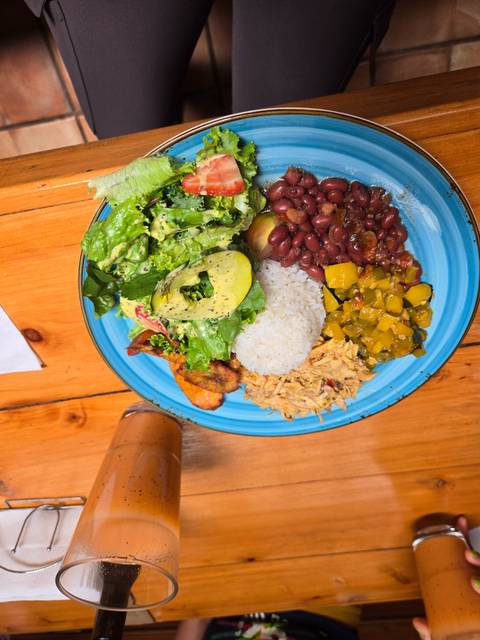       Colorful Costa Rican casado plate with rice, beans, salad, plantain and shredded chicken
  