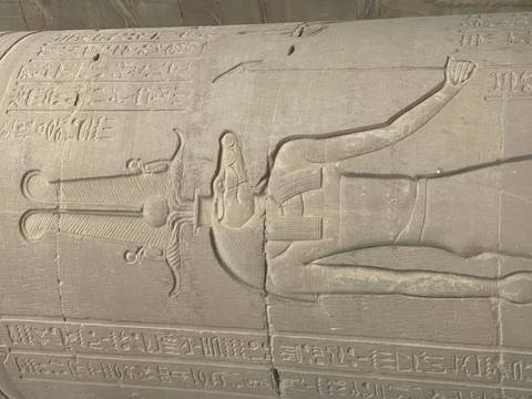       Relief carving of the crocodile-headed god Sobek with hieroglyphs on sandstone wall.
  