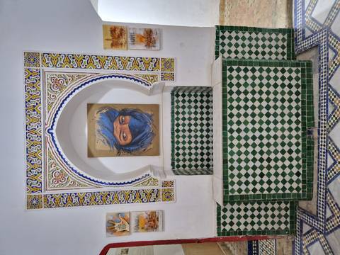       Decorative niche with Berber portrait surrounded by colorful Moroccan mosaic tiles
  