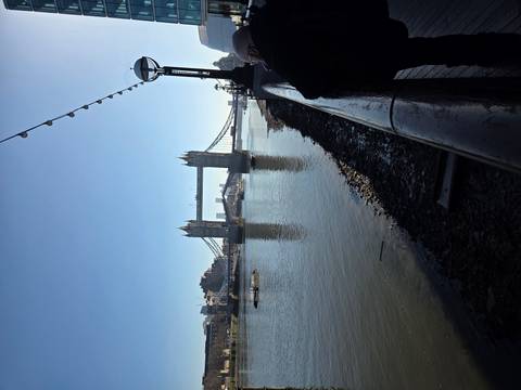       Tower Bridge spanning the River Thames under a clear blue morning sky.
  