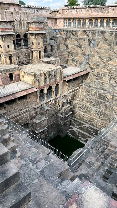       Aerial view down the dizzying geometric layers of Chand Baori stepwell in Rajasthan.
  