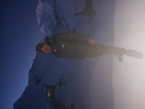       Blurry night portrait of trekker in snowy pass with fogged lens.
  