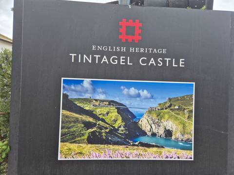       Informational sign for English Heritage’s Tintagel Castle showing a large photo of the site.
  