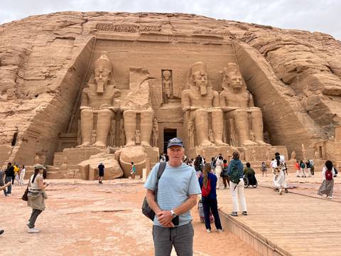       Grand façade of Abu Simbel’s Great Temple with tourists gathering in front
  