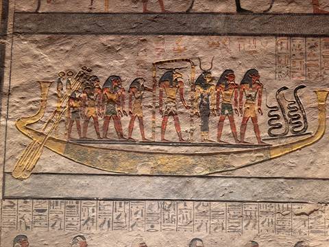       Ancient Egyptian wall painting of deities aboard solar boat
  