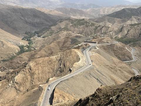       Closer view of winding highway carved into steep rocky mountainsides
  