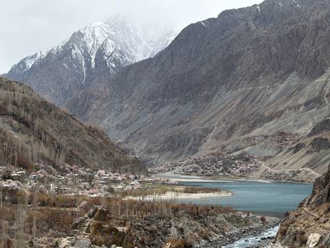       Wide valley view of turquoise lake, blossoming villages and snow-capped peaks
  