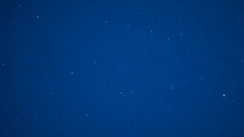       Long-exposure shot of a deep blue night sky sprinkled with countless stars
  