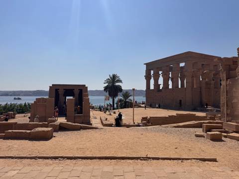       Ancient columns and ruins of Philae temple complex overlooking Nile waters
  