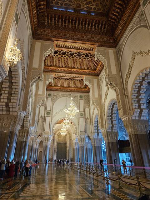       Again the lavish interior of Hassan II Mosque with gleaming chandeliers and carved arches.
  