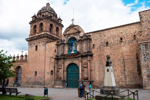       Historic stone church with ornate bell tower and turquoise wooden door in Cusco’s colonial center.
  
