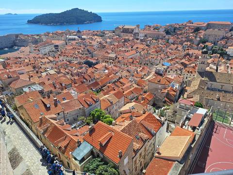       Aerial panorama of the terracotta rooftops of Dubrovnik’s medieval walled city.
  