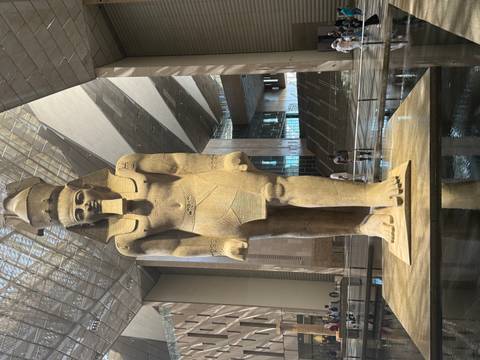      Colossal statue of Pharaoh Ramses II dominates the skylit atrium of the Grand Egyptian Museum.
  