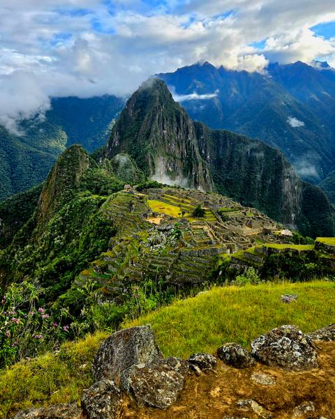       Richly coloured, mist-kissed view of Machu Picchu terraces framed by jagged peaks
  