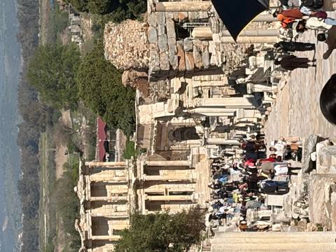       Crowds exploring stone ruins and columns of ancient Ephesus street
  
