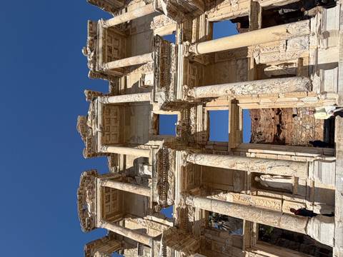       Upward view of restored Celsus Library façade under flawless blue sky
  