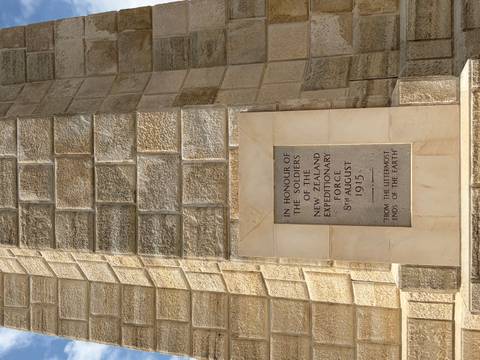       Stone plaque honouring New Zealand soldiers set into memorial wall
  