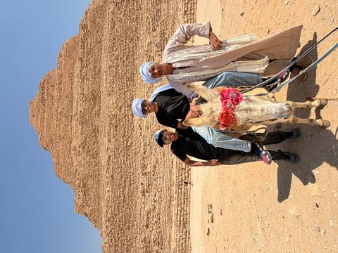       Two boys on donkey with local guide before Step Pyramid of Saqqara
  