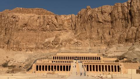       Terraced Mortuary Temple of Hatshepsut set against towering desert cliffs
  