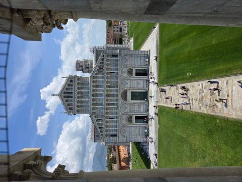       Front façade of Pisa Cathedral with Leaning Tower visible behind, photographed from above
  