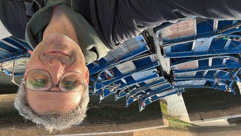       Selfie overlooking rows of bright blue wooden fishing boats moored in Essaouira’s harbor.
  