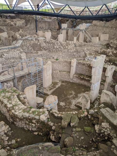       Closer view of ancient circular stone structures and monumental pillars at Göbekli Tepe archaeological site.
  