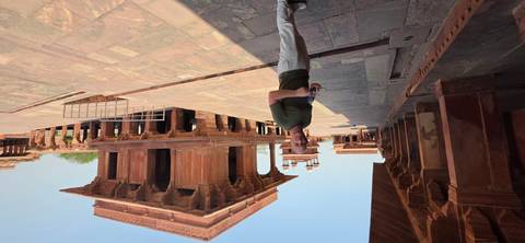       A visitor explores the red-sandstone pavilions of Fatehpur Sikri’s royal complex.
  