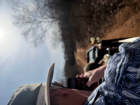       Safari jeep speeds along a dusty track in Ranthambore as a traveler snaps photos.
  