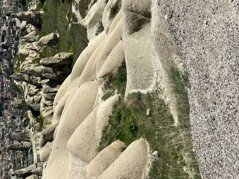      Eroded beige rock formations and valleys typical of Cappadocia.
  