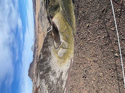       Expansive volcanic crater field with colourful mineral tones and distant snow-capped peaks.
  