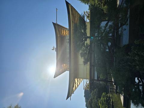       The sun flares behind Kyoto’s Golden Pavilion (Kinkaku-ji) reflecting warm light on its gold exterior.
  