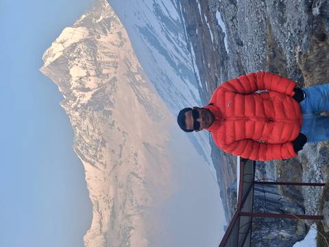       Single trekker enjoying mountain vistas near Annapurna Base Camp.
  