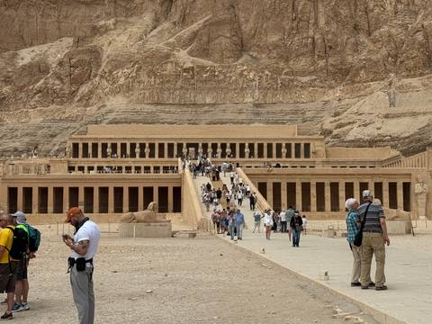       Visitors ascend the grand ramps of Hatshepsut’s Mortuary Temple carved into the cliffs at Deir el-Bahari.
  