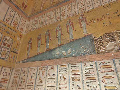       Colorful, well-preserved wall reliefs depicting ancient Egyptian deities inside a tomb in the Valley of the Kings.
  