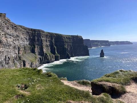       Dramatic panorama of the Cliffs of Moher towering over the Atlantic with sea stack below
  