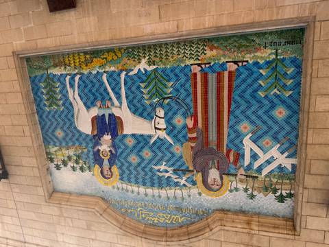       Colorful tiled mosaic showing biblical figures with a donkey and birds by water.
  